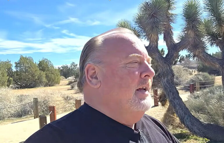Jimi The Hobo walking through a sunlit park during a morning health reset session.